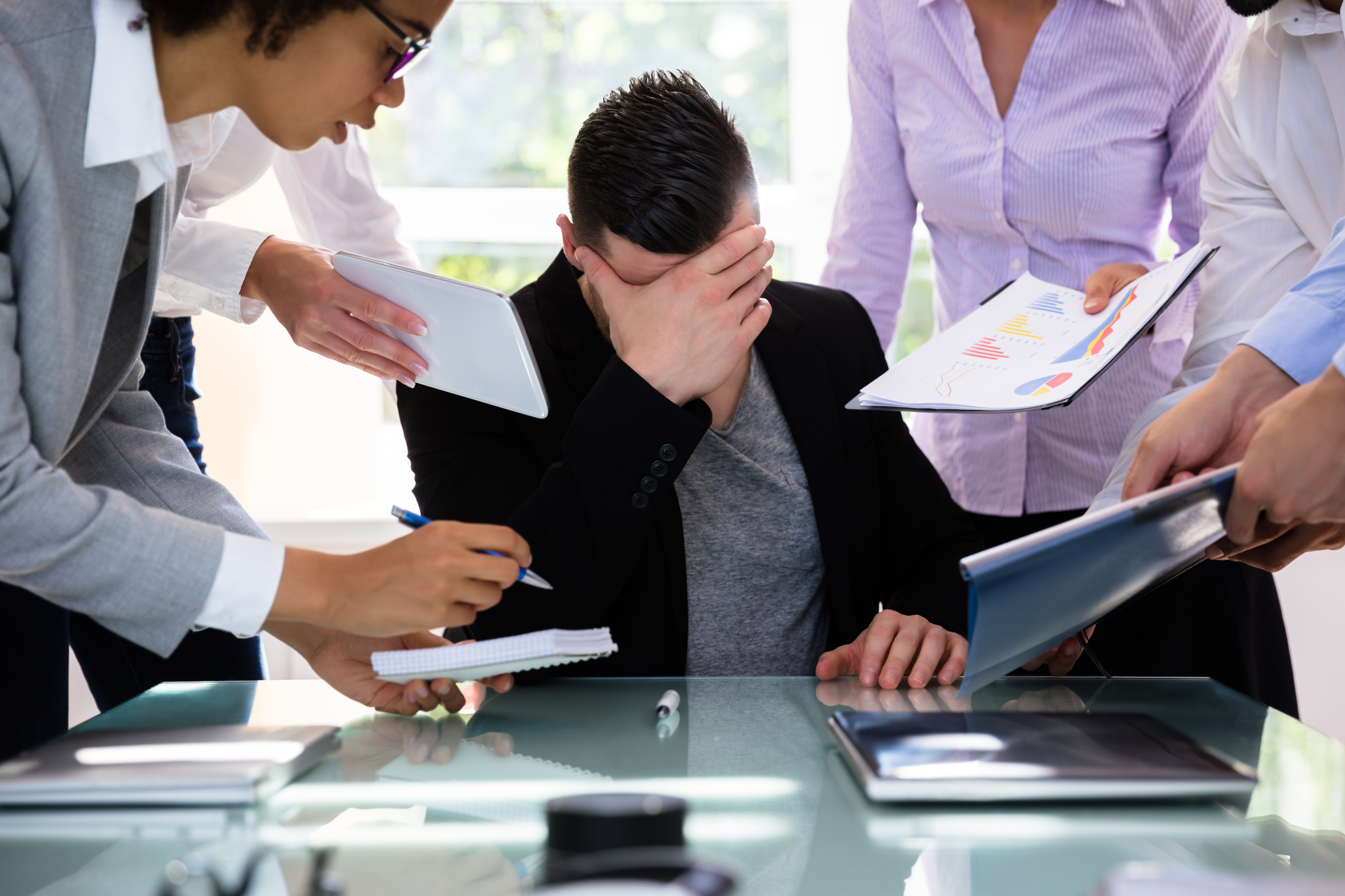 Overwhelmed business professional struggling to manage a heavy workload