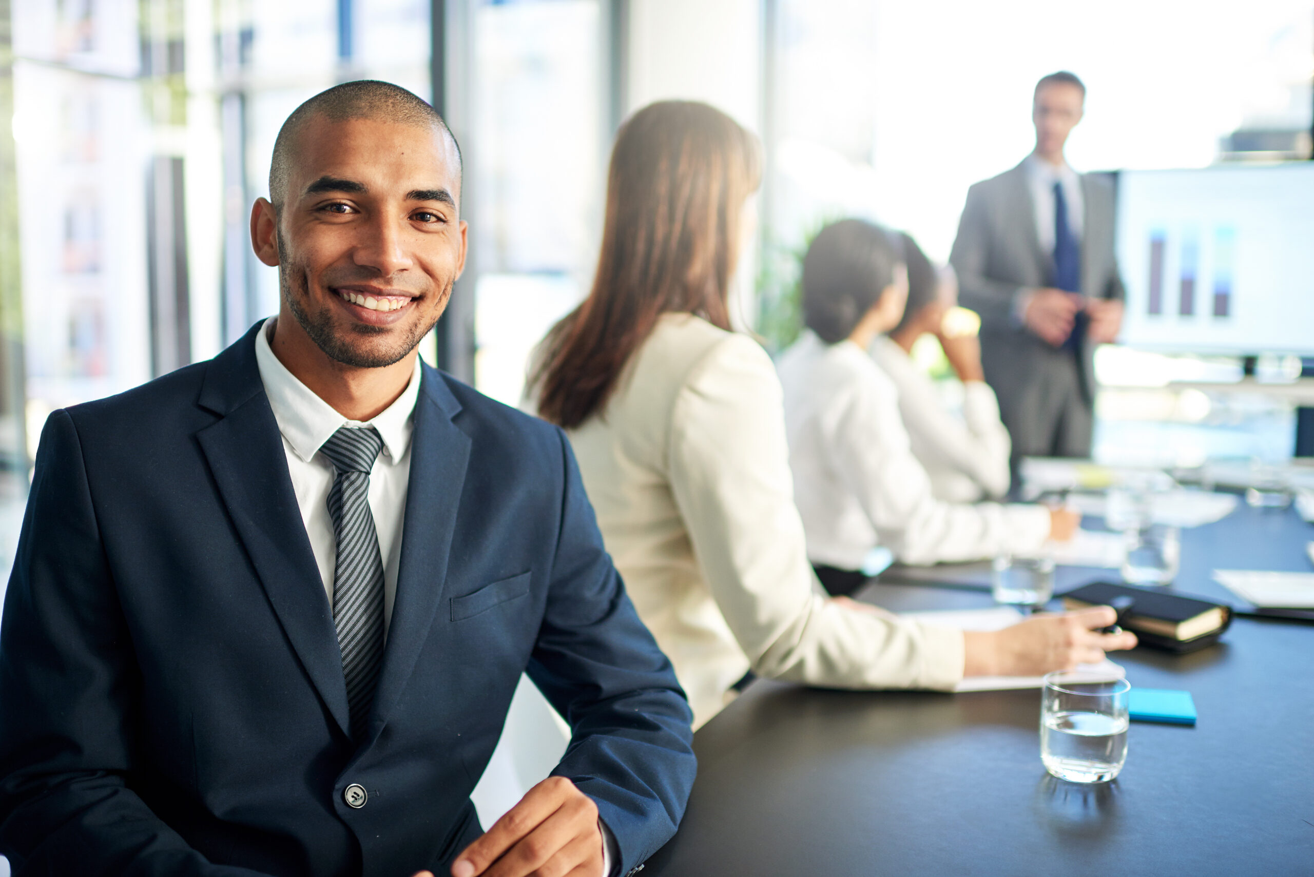 A young field sales professional looking confident while in a meeting.